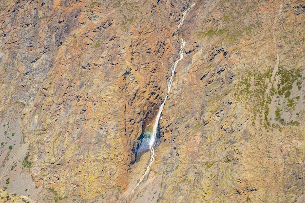 View from mountain pass katuyaryk of waterfall which falls from a cliff in altai russia