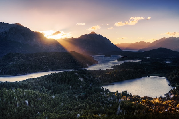 View from the mountain of a ray of sunlight illuminating a lake