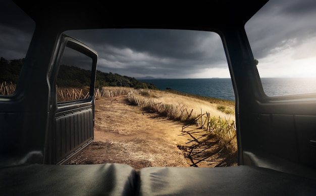 View from the open car trunk by top of mountain and sea.