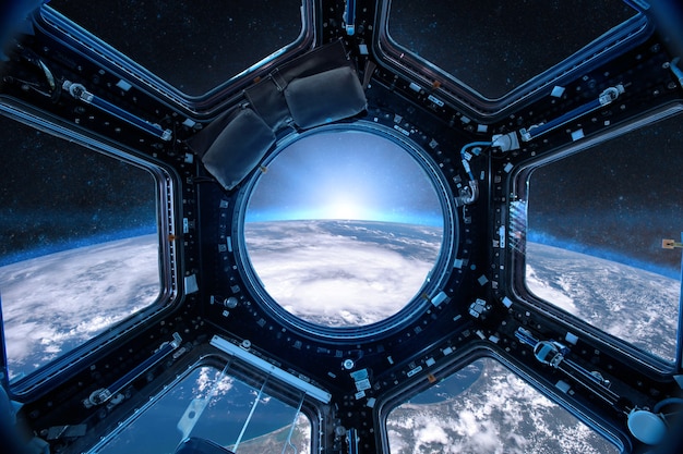 View from a porthole of space station on the Earth Elements of this image furnished by NASA