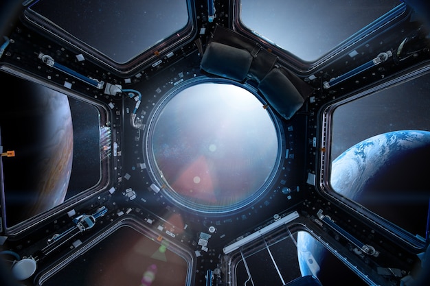 View from a porthole of space station on the Earth Elements of this image furnished by NASA