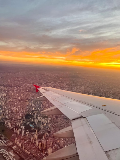 View from the window of an airplane turbine of an airplane under the Sao Paulo Brazil At the sunset