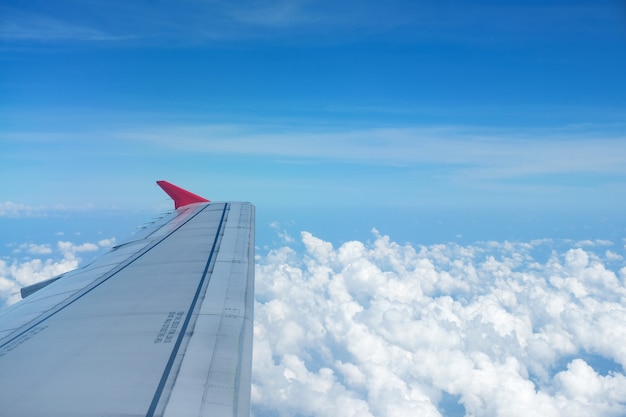 View from windows airplane, flying high above the beautiful fluffy clouds.