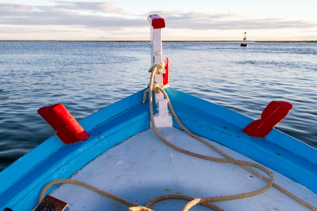 View of a front part of a traditional Portuguese fishing boat in the sea.