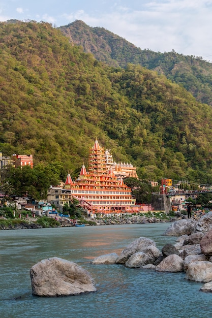 View of Ganga river embankment Lakshman Jhula bridge and Tera Manzil Temple Rishikesh India