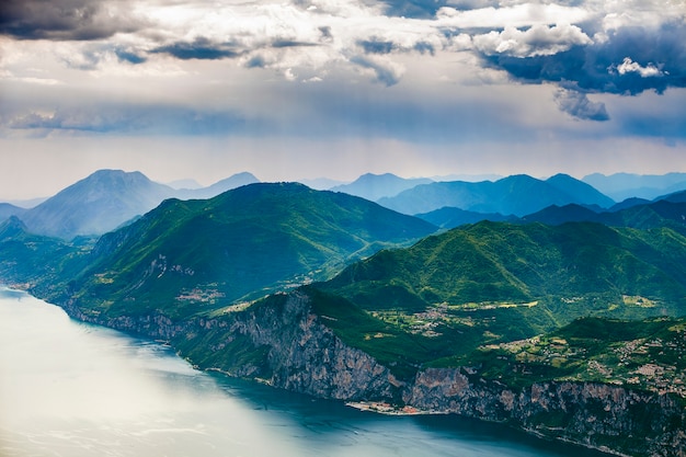 View of Garda lake and surrounding mountains with impressive clouds