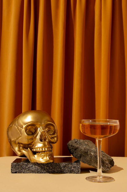 View of golden skull with alcoholic drink