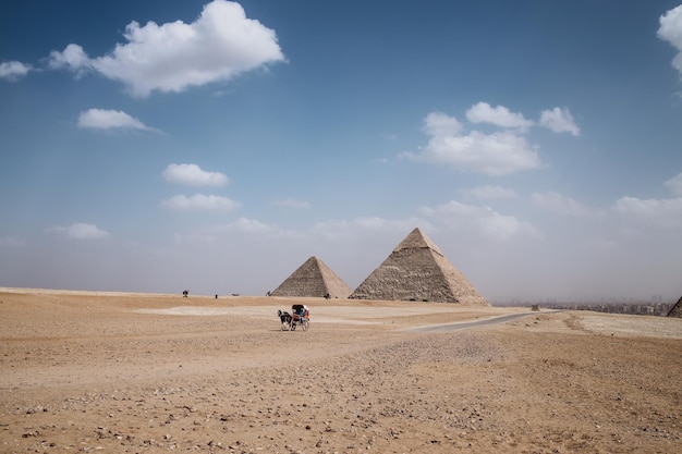 View of the great pyramids of Giza, Egypt in the middle of the desert with the traveler in his horse