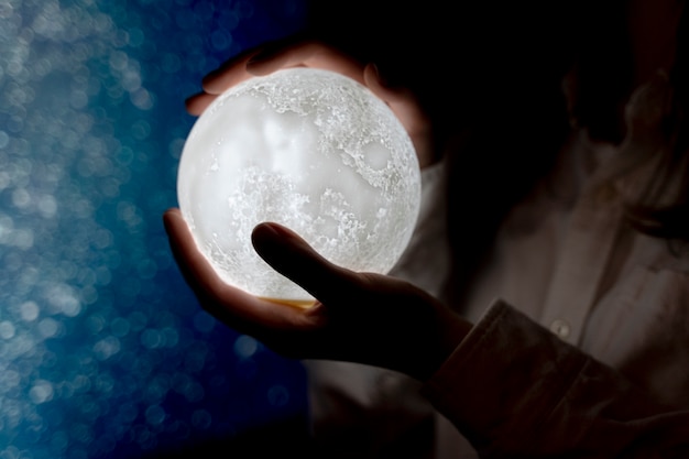 View of hands holding moon light