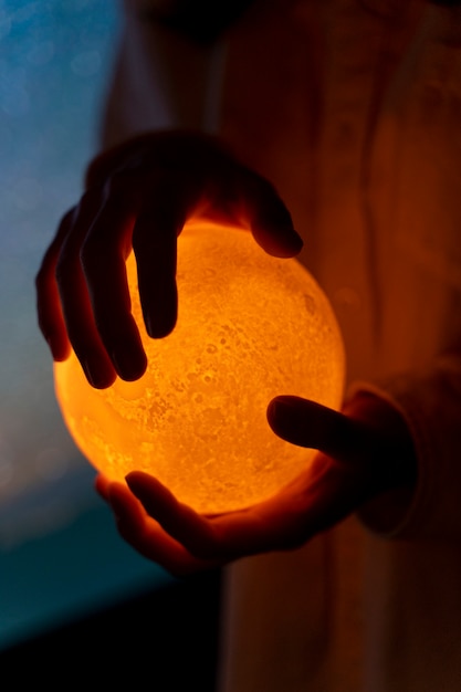 View of hands holding moon light