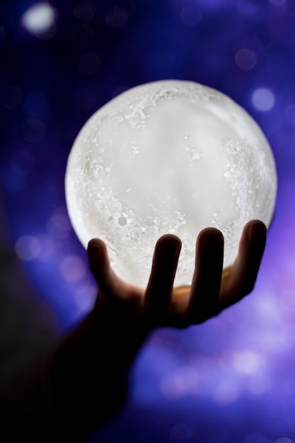 View of hands holding moon light