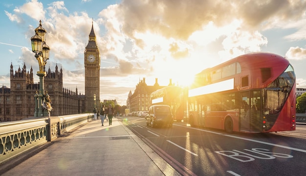 view of  the Houses of Parliament and Big Ben with red bus at sunset in london. ideal for websites and magazines layouts