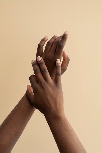 View of human hands against colored background