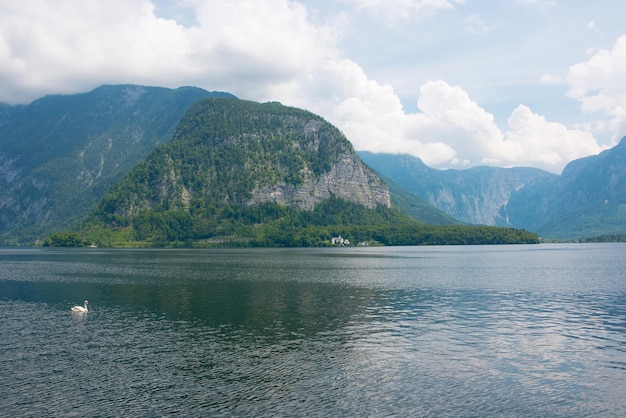 View idyllic Alpine mountains and lake. Sunny summer day in town Hallstatt, Austria, Europe