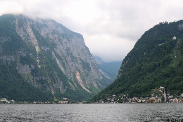 View idyllic Alpine mountains and lake. Sunny summer day in town Hallstatt, Austria, Europe