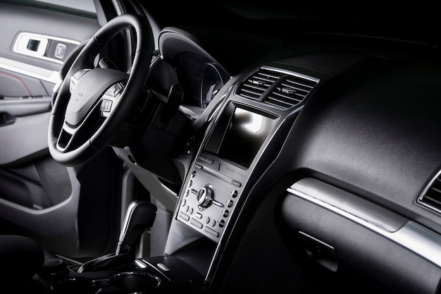 View of the interior of a SUV car, modern dashboard with touch screen, black leather seats ideal for the driver