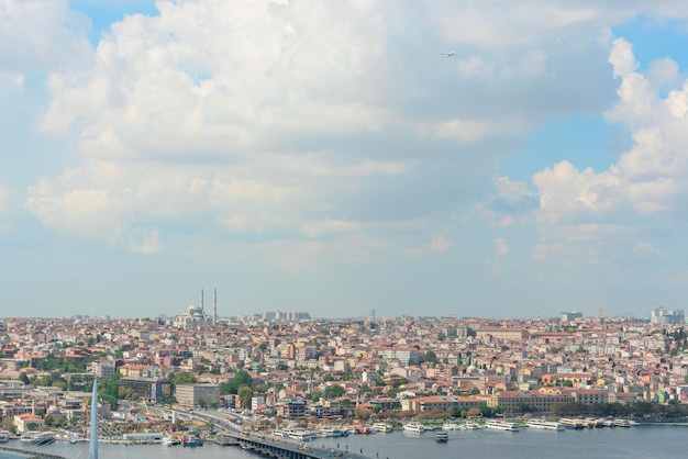 View of Istanbul on a sunny summer day with a bright blue sky with white clouds and a flying plane Travel concept