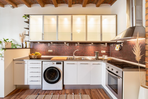 View of the kitchen with modern appliances backlit glass panels large stove and extractor hood and