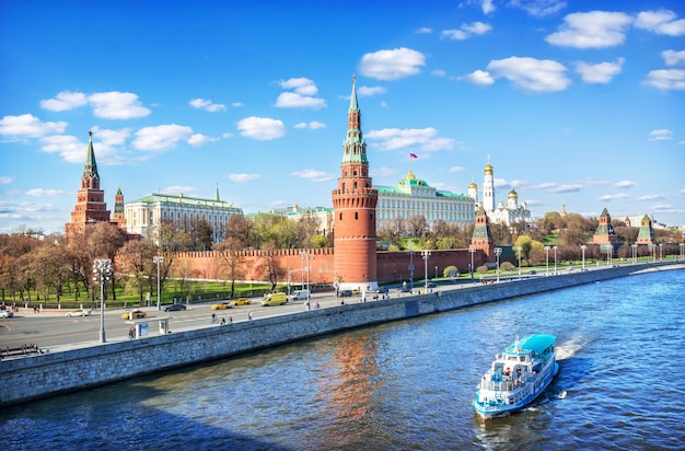 View of the Kremlin and a boat on the Moskva River in Moscow on a summer sunny day