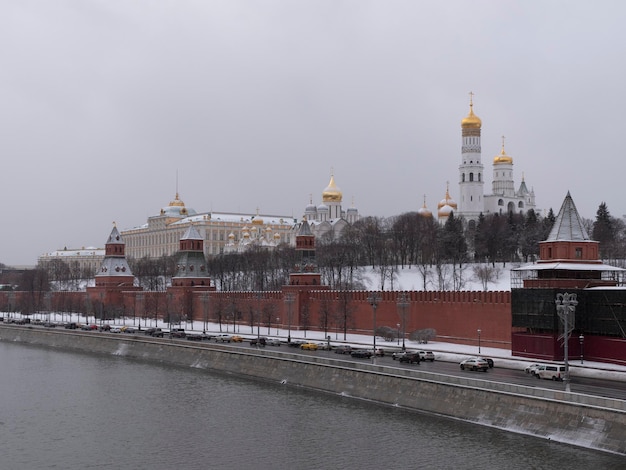 View of the Kremlin Embankment and cathedrals in Moscow Russia at wintertime during snowfall