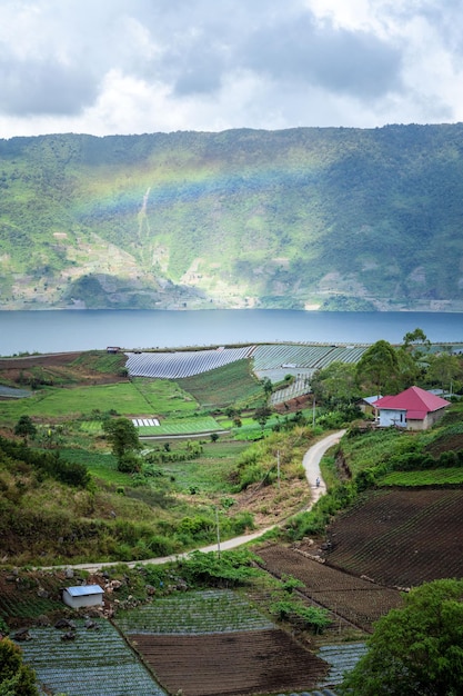 view of the lake in the mountains with rainbow