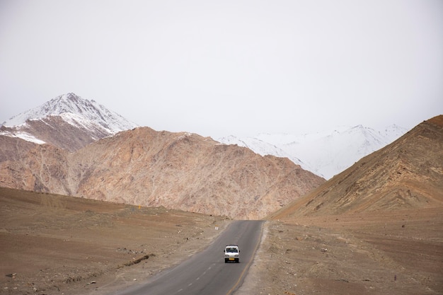 View landscape beside road with Indian people drive car on Srinagar Leh Ladakh highway go to view point of Confluence of the Indus and Zanskar River at Leh Ladakh in Jammu and Kashmir India in winter