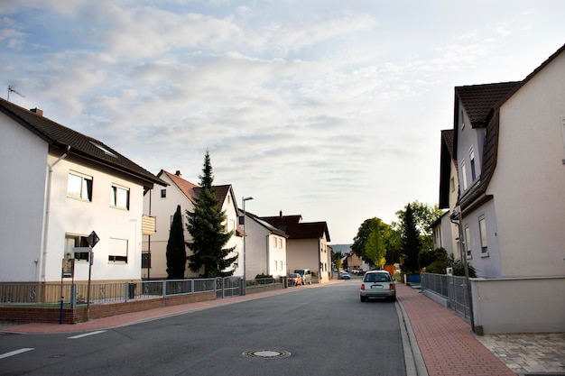 View landscape and cityscape with traffic road and German people walking on pavement beside road at Sandhausen district and village in morning time in Heidelberg Germany