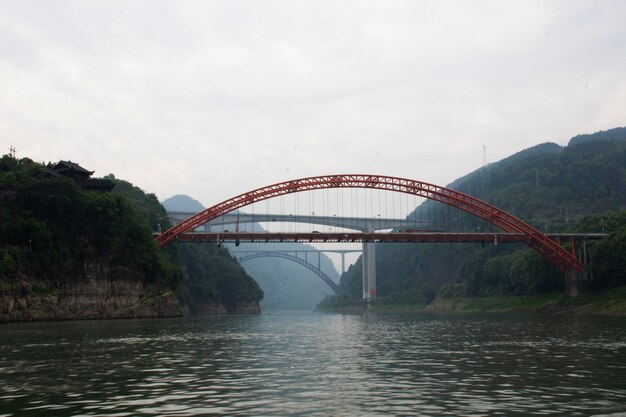 View landscape mountain cliffs and youshui river with Youshui Railway Red Bridge in antique Furong Zhen and Tujia ancient town city for chinese people travelers use journey at Yongshun in Hunan China