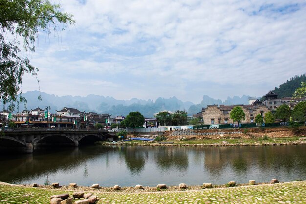 View landscape mountain Wu ling yuan cityscape building house home of Zhangjiajie and life lifestyle local chinese people riverside stream water from Suoxi Reserve lake on May 9 2024 in Hunan China