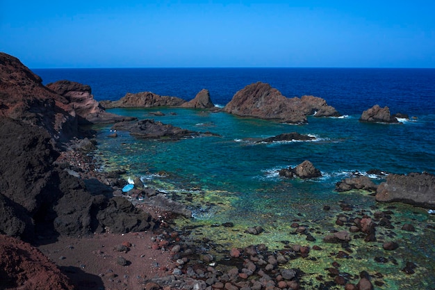 View of the lava beach of Linosa Called Faraglioni