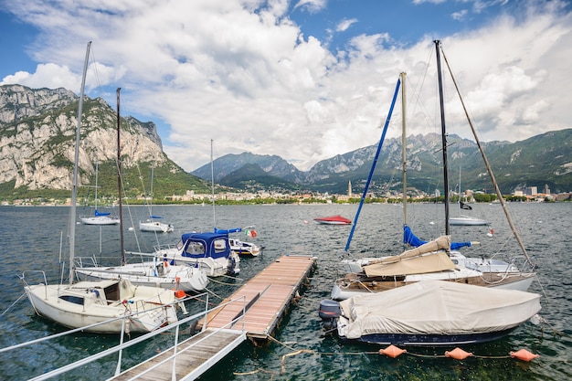 View of Lecco, Italy, with boats at foreground