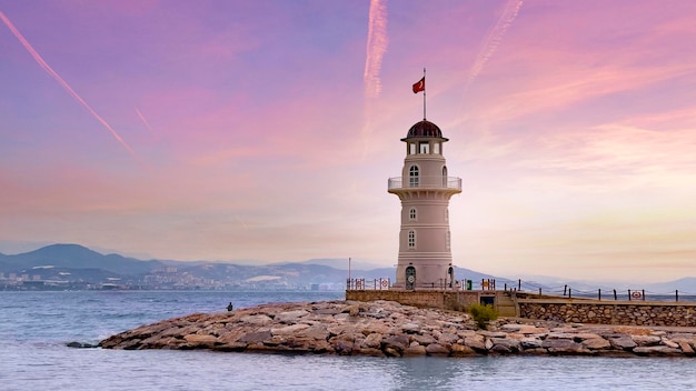 View of the lighthouse at a scenic beautiful pink sunset. Wallpaper, background