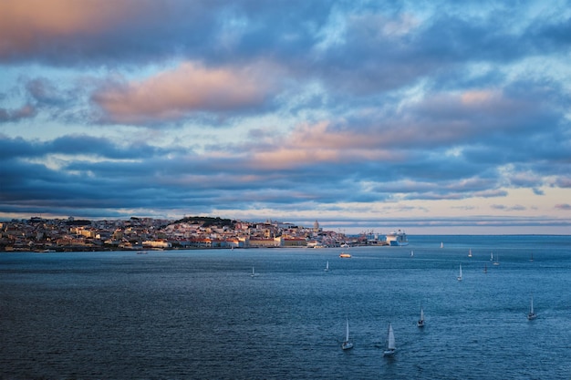 View of lisbon view over tagus river with yachts and boats at sunset lisbon portugal