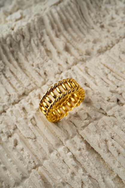 View of luxurious golden ring with white dust