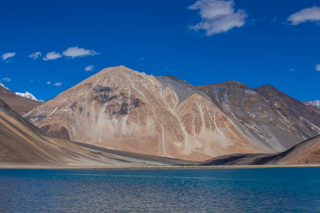 View of majestic rocky mountains against the blue sky and lake Pangong in Indian Himalayas Ladakh region India Nature and travel concept