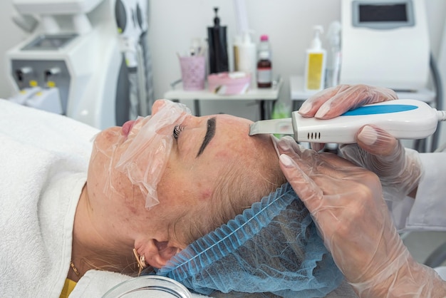 View of making a moisturizing nourishing mask for a client's face in a beauty salon