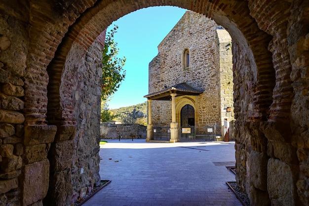 View of the medieval church from the gate of the arched wall. Buitrago de Lozoya Madrid.