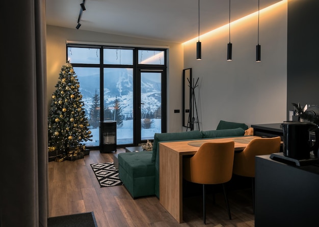 View of modern interior of house with snowy mountain view decorated for holidays