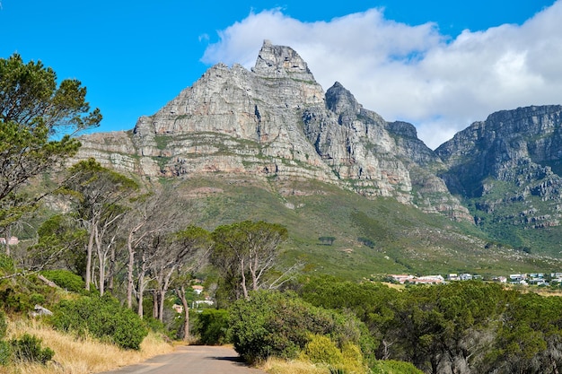 Below view of a mountain peak in South Africa against a cloudy blue sky with copy space Scenic nature landscape of a remote hiking and travel destination to explore near Table Mountain in Cape Town