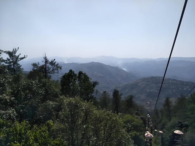 a view of a mountain valley from a cable car