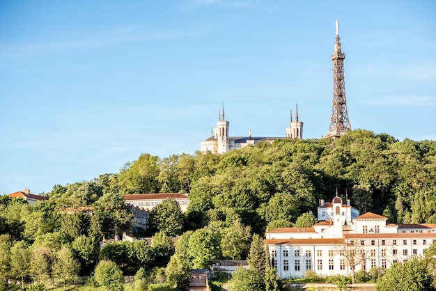 View on the mountain with Notre-Dame cathedral and metallic tower in Lyon city in France