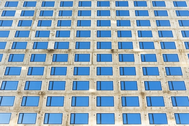 View of a new building made of concrete monolith new inserted window frames