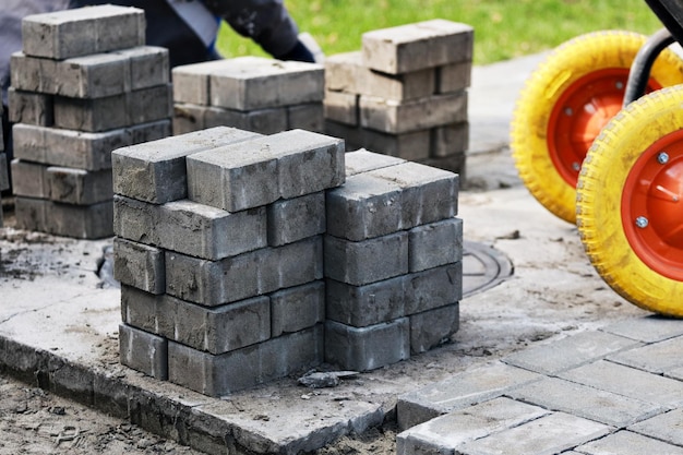 View of new paving slabs and concrete blocks on summer day at construction site Stone blocks stand in stack