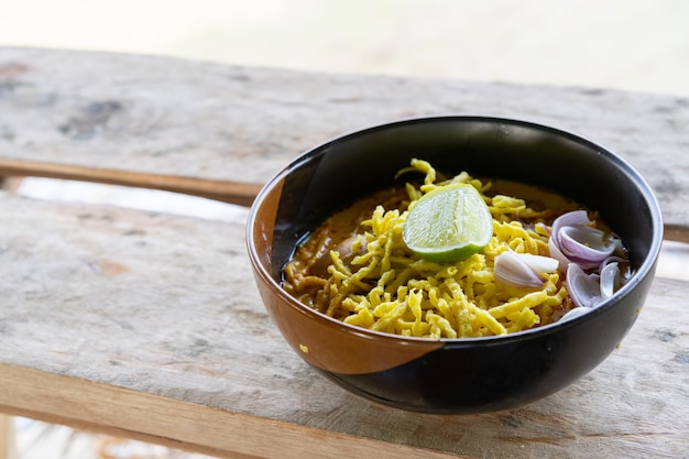 View of Noodle with curry soup and chicken (Khao Soi) food of Northern Thailand traditional 