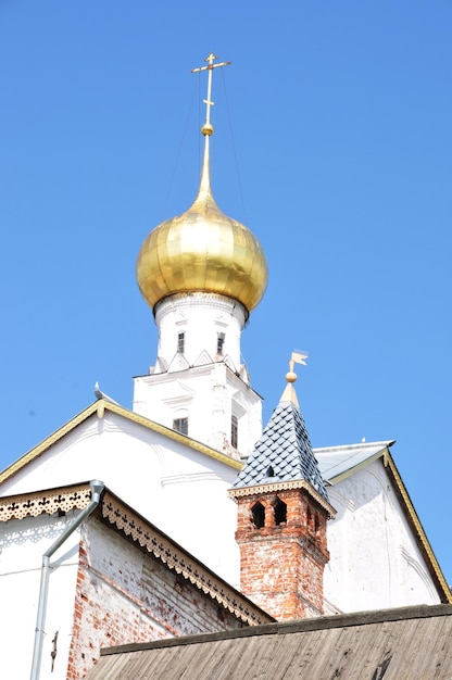 View of the old church. Golden dome of the church with a cross on a background of blue sky