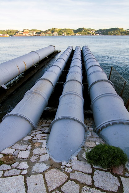 View of old sewage pipes leading to a river.