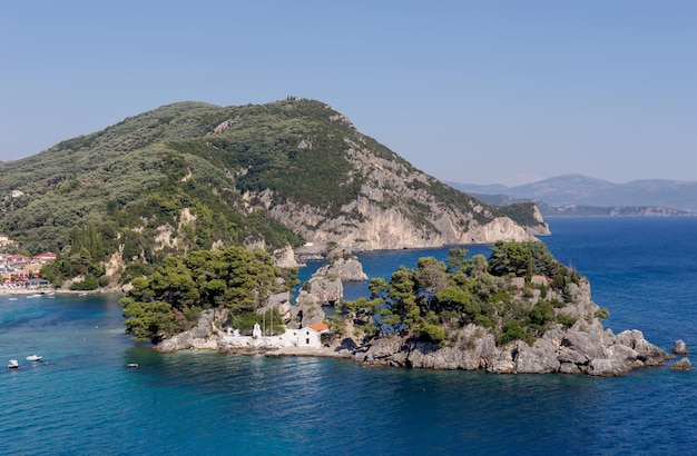 View of the Orthodox Christian Church of the Mother of God on a small island in a sunny summer day resort city Parga region of Epirus Greece