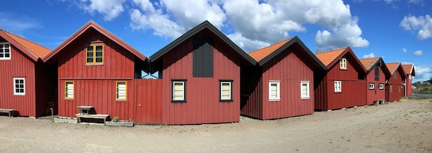 View panoramic on red traditional cabins under blus sky in sweden