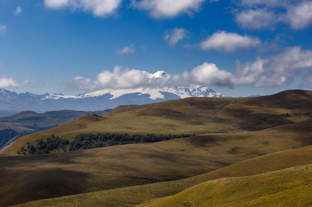 View of the peaks of Mount Elbrus with clouds in the sky.