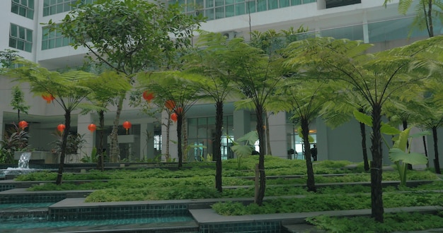 View of picturesque garden with fountain against modern building kuala lumpur malaysia